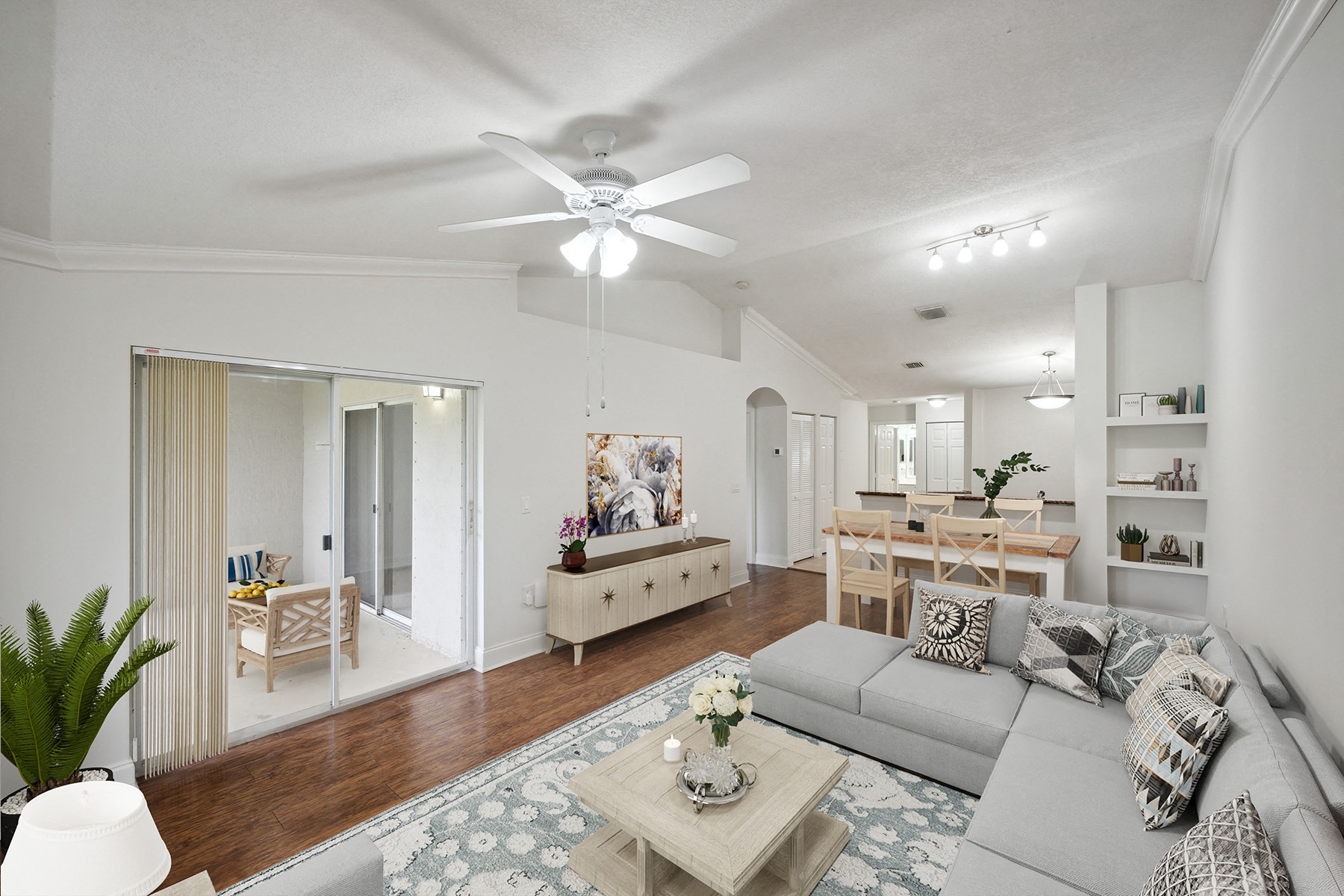 a living room with a couch and a ceiling fan